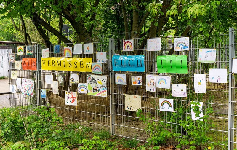 Closed municipal daycare centre Am Mühlenbruch in Essen, teachers have hung self-painted pictures of the children on a fence of the daycare centre with the slogan We miss you, effects of the corona crisis in Germany