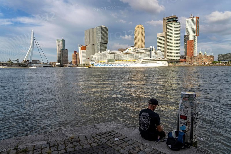Rotterdam, skyline at the Nieuwe Maas, Erasmus Bridge, skyscrapers at the Kop van Zuid district, cruise ship Aida Prima at the Cruise Terminal, Veerhaven, historic ships, sailing boats, pier, Netherlands