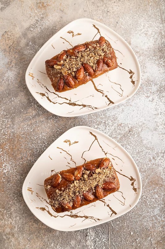 Caramel and almond cake on brown concrete background. top view, flat lay, close up