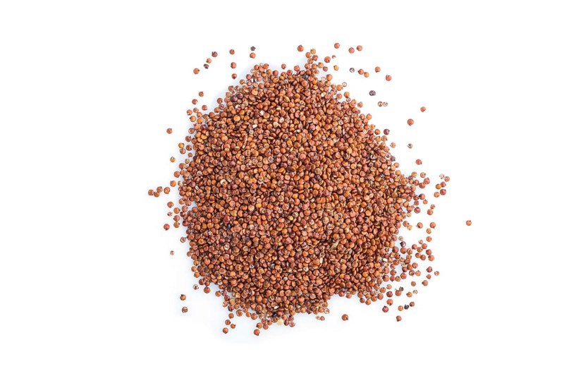 Pile of raw red quinoa isolated on white background. Top view, flat lay, close up, macro