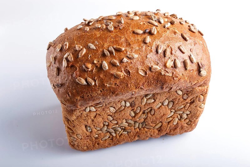 Rye bread with sunflower seeds isolated on white background. close up