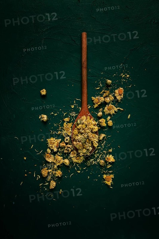 Chrysanthemum buds, tea, on a wooden boat, top view, no people