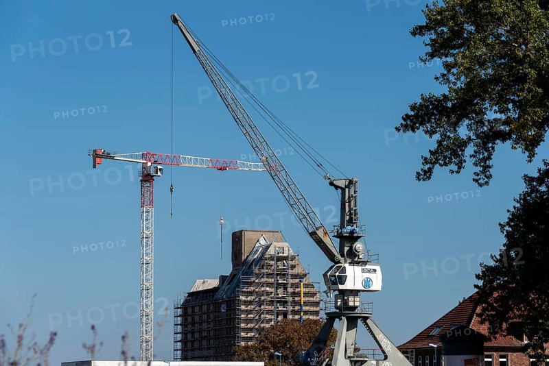 Old silo building, warehouse, in front of it construction crane and harbour crane, Magdeburg Port of Science, Saxony-Anhalt, Germany, Europe