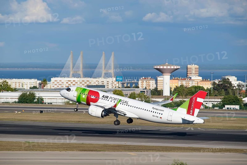 Lisbon, Portugal - September 2, 2023: TAP Air Portugal Airbus A321-251N passenger plane take off in Humberto Delgado Airport in Lisbon with Vasco da Gamma bridge in background