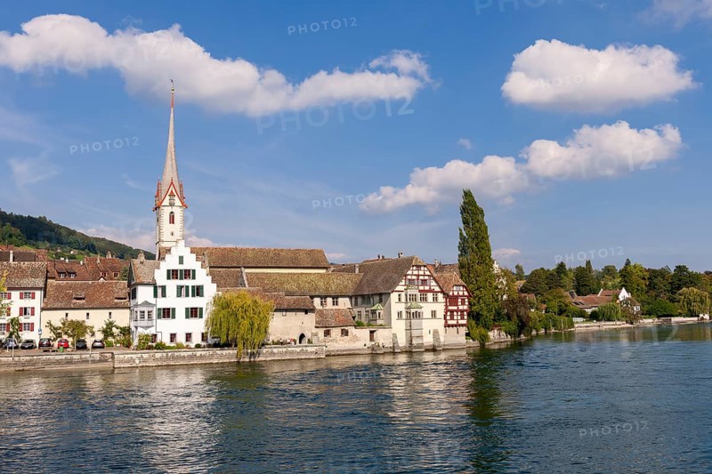 Church with high tower on the riverbank, surrounded by half-timbered houses and trees, view of the old town of Stein am Rhein with St. George's Abbey, Stein am Rhein, Canton Schaffhausen, Switzerland, Europe