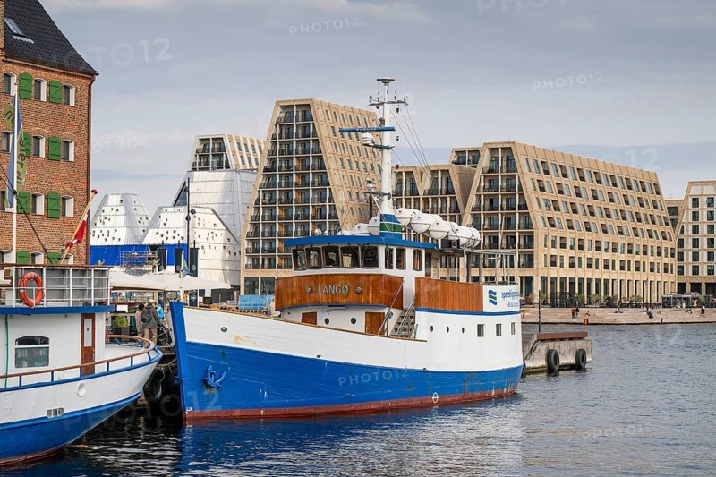Boat anchored in Nyhavn in the Frederiksstaden district, in the background contemporary architecture on Paper Island, Copenhagen, Denmark, Europe