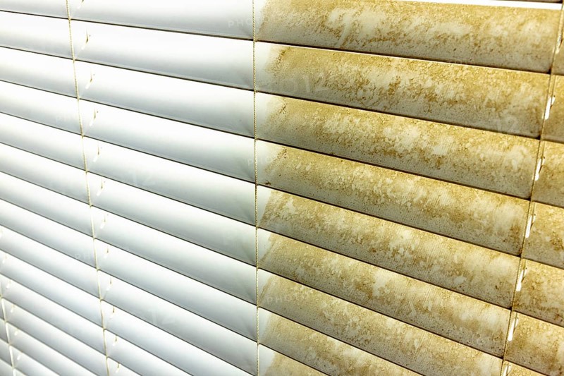 Residential window shades showing the before and after of a good cleaning, one side clean and one side dirty