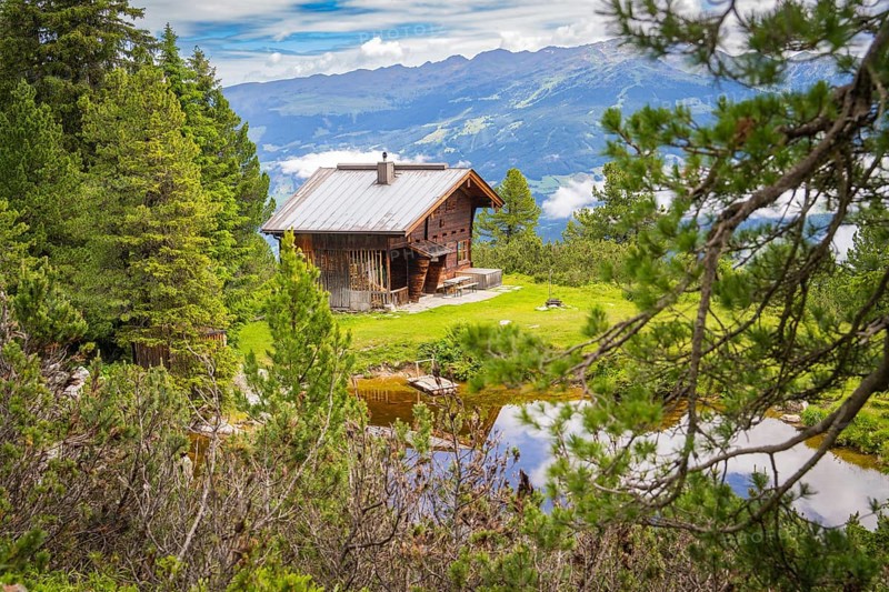 Secluded hut in the mountains, surrounded by forest and meadow, peaceful atmosphere, Penken, Zillertal. Austria