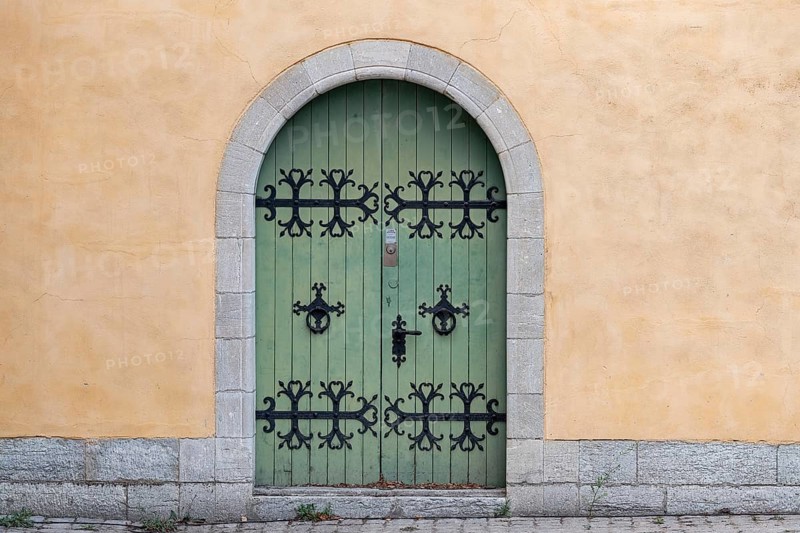 Green wooden door with black, iron fittings and round arch, Old Town, Hanseatic City of Visby, UNESCO World Heritage Site, Gotland Island, Sweden, Europe