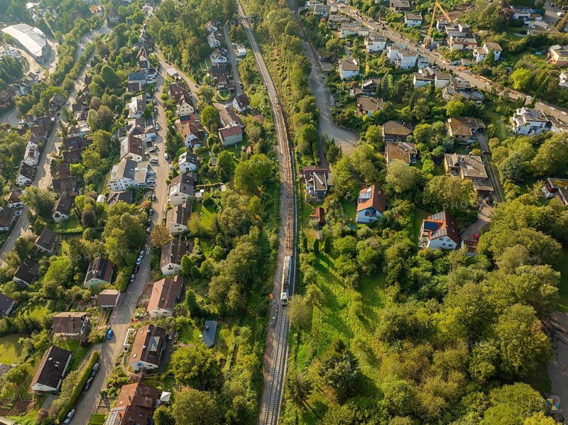Rails and roads between densely overgrown residential areas, track construction, rail delivery for Hermann Hessebahn, Calw, Black Forest, Germany, Europe