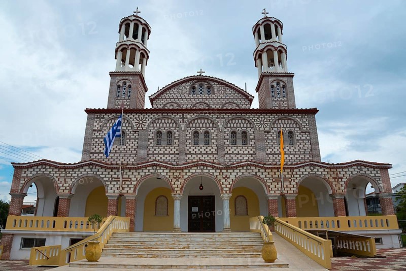 Imposing church with two towers and flags against a cloudy sky, Church of Agios Georgios, Nea Potidea, Kassandra peninsula, Chalkidiki, Central Macedonia, Greece, Europe
