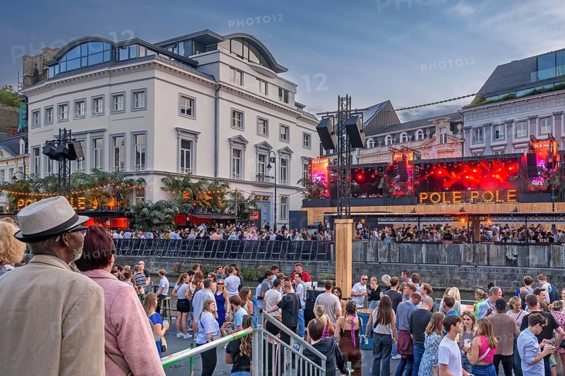 Spectators on grandstand at the Graslei watching Pole Pole podium during Gentse Feesten, Ghent city festival, summer festivities in Flanders, Belgium, Europe
