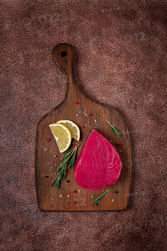 Fresh red tuna fillet, for steak, raw, top view, on a cutting board, no people