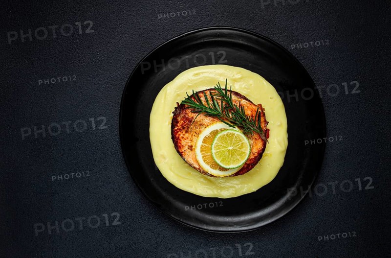 Salmon steak, fried, mashed potatoes, top view, rosemary, lemon and lime, homemade, one serving, no people