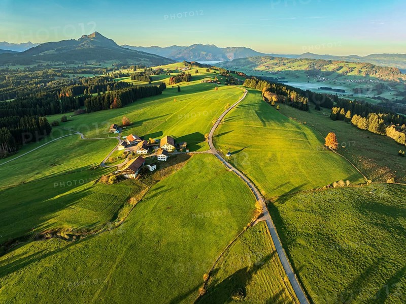 Mountain range near village Wertach, view to mt. Gruenten, sunrise, fog in valley, traditional farm, aerial view, Allgaeu, Bavaria, Germany, Europe