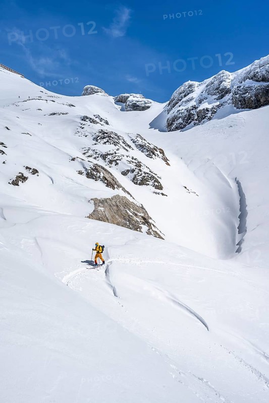 Lone ski tourer in mountain landscape with snow, ascent to Wildstrubelhütte, Bernese Alps, Switzerland, Europe