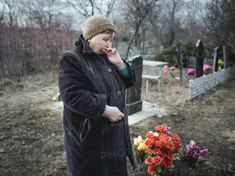 Ludmilla (68) mourns her grandson, who died at the front a month earlier, at the cemetery. The parents have not left the house since and have given in to alcohol, Spodovivka, Ukraine, Europe
