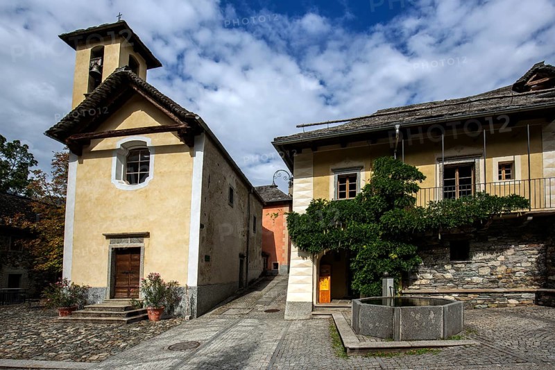 Church and typical Ticino stone houses in the mountain village of Bordei, Centovalli, Canton Ticino, Switzerland, Europe