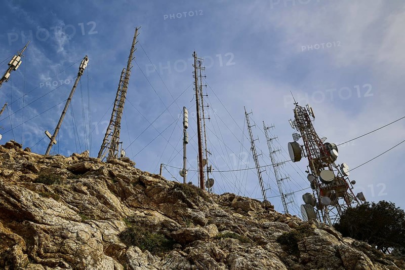 Several radio masts and antennas towering into the cloudy sky on a rocky hill, mountain top, antenna installations, Profitis Ilias, Rhodes, Dodecanese, Greek Islands, Greece, Europe