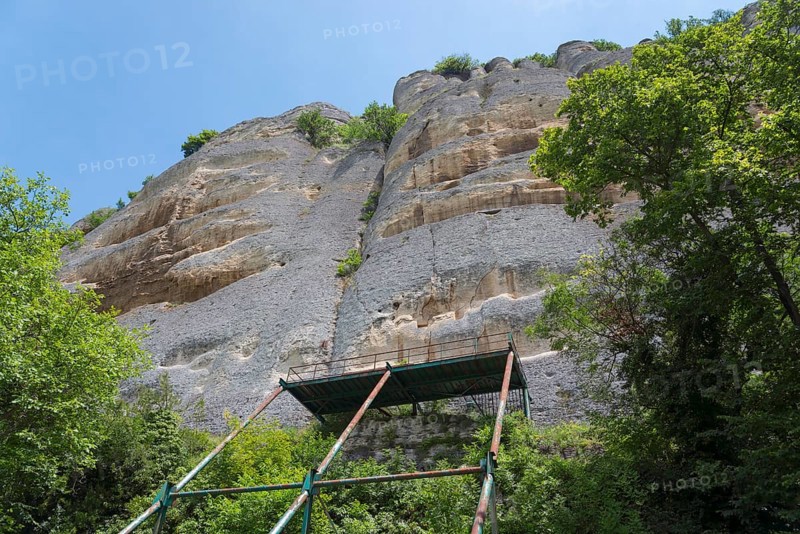 Scaffolding in front of a high rock face surrounded by trees and blue sky, rock relief, Horsemen of Madara, Madara, Shumen, Shumla, Unesco World Heritage Site, Bulgaria, Europe