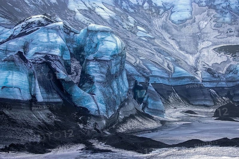 Mýrdalsjökull glacier with layers of black volcanic ash, ice cap on the top of the active Katla volcano in the south of Iceland near Vík í Mýrdal