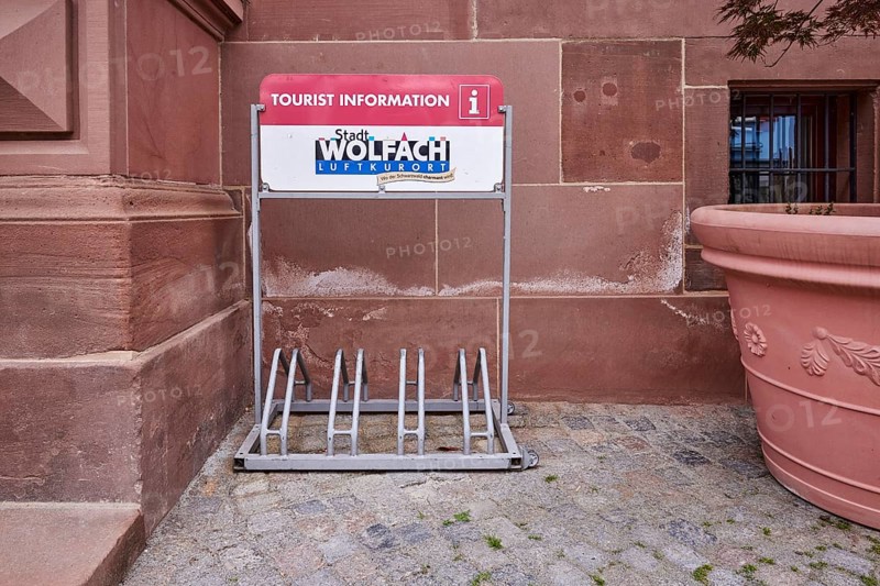 Bicycle stand with advertising City of Wolfach, tourist information centre, flower bucket, main street, Wolfach, Black Forest, Ortenaukreis, Baden-Württemberg, Germany, Europe
