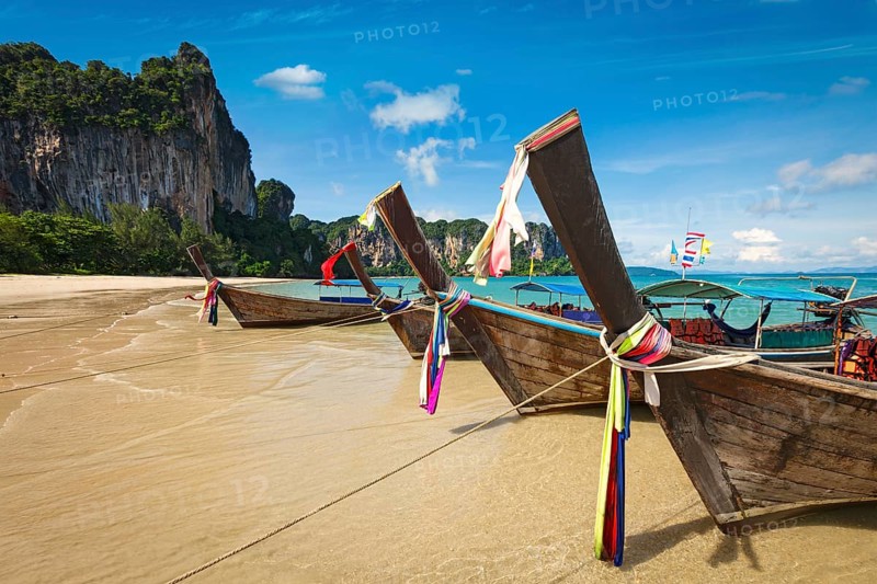 Long tail boats on tropical beach in Thailand