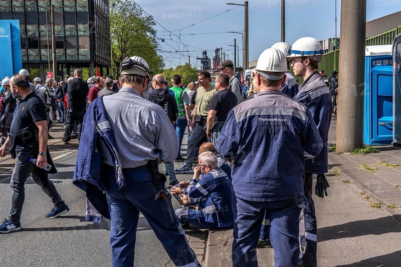 Steelworkers at a demonstration in front of the headquarters of ThyssenKrupp Steel Europe in Duisburg, against massive job cuts, after the participation of a foreign investor in the group, in the background the blast furnaces 8 and 9, Duisburg North Rhine-Westphalia, Germany, Europe