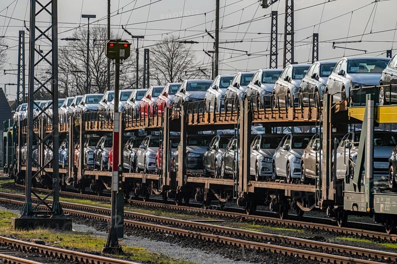 VW plant, Emden, new cars, car transporter, car train, goods train, with VW vehicles, Lower Saxony, Germany, Europe