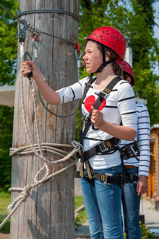 Young girl in climbing park, climbing, action, safety, belay, belay rope, belay technique, belay hook, courage, brave, leisure, hobby, height, fear of heights, overcoming, sport