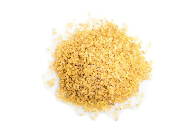 Heap of bulgur isolated on white background. Top view, flat lay, close up, macro