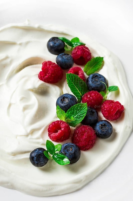 Breakfast, yogurt with fresh berries, raspberries and blueberries, on a white background, selective focus, no people, healthy food