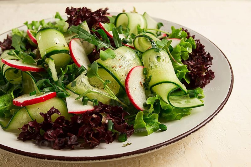 Vegetable salad, radishes and cucumbers, radish micro-greens, lettuce leaves, green onions, homemade, no people