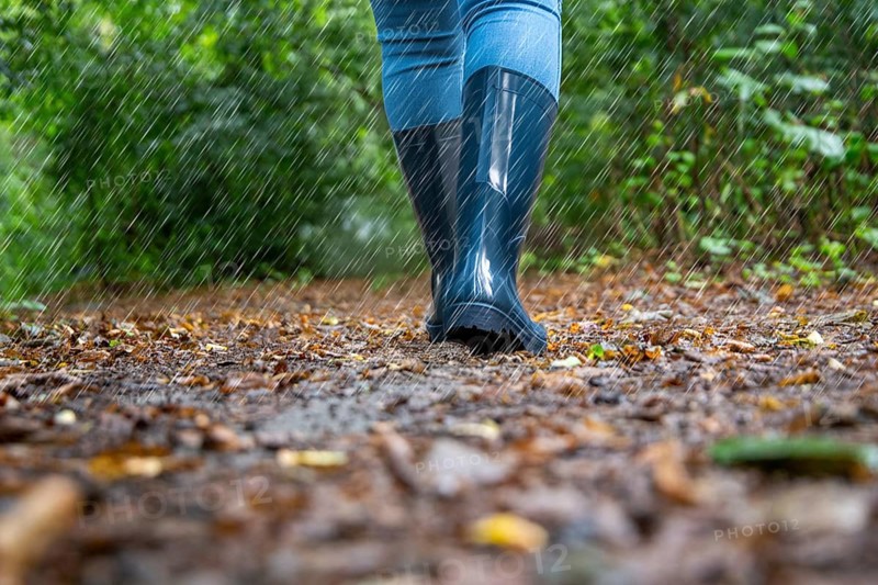 Woman on a walk in the rain (symbolic image, composing)