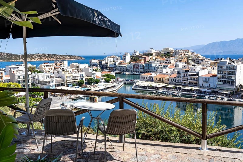 Taverna above the village of Agios Nikolaos, in the eastern part of Crete, view over Lake Voulismeni, connected to the sea, old town, Greece, Europe