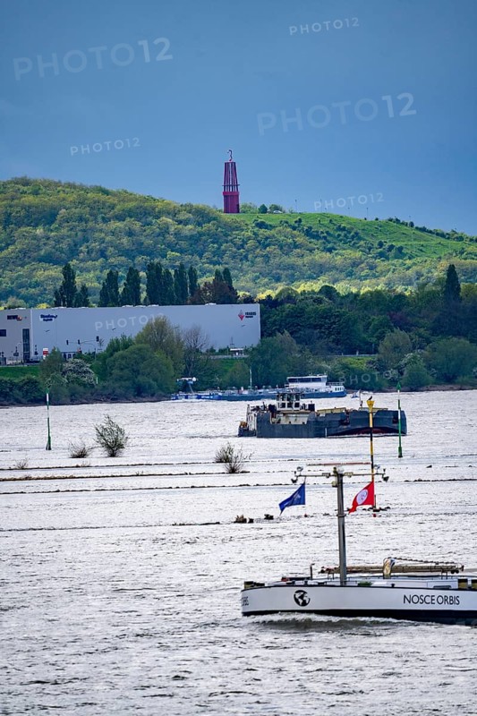 Cargo ships on the Rhine near Duisburg, in the background the Rheinpreußen spoil tip in Mörs, with the Geleucht, an observation tower in the shape of a miner's lamp, North Rhine-Westphalia, Germany, Europe