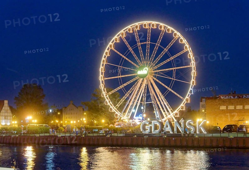 The Ferris wheel illuminated in the evening on the Motlawa, Motlawa, and the lettering Gdansk, Danzig, in the harbour district of Danzig. Gdansk, Pomerania, Poland, Europe