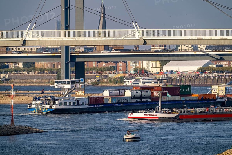 Cargo ships on the Rhine near Düsseldorf, bridge over the Media Harbour, Oberkassler Rhine Bridge, old town bank, North Rhine-Westphalia, Germany, Europe