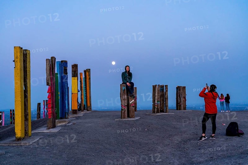 The Haniel spoil tip, 185 metre high spoil tip, at the Prosper Haniel mine, closed in 2019, artwork Totems by the sculptor Augustin Ibarrola, full moon, Bottrop, Germany, Europe