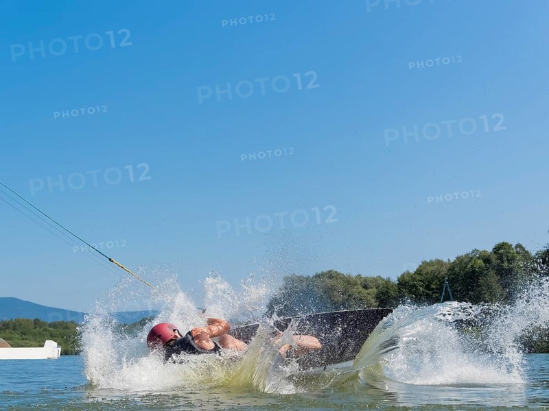 Man makes somersault with wakeboard, fall, water ski and wakepark