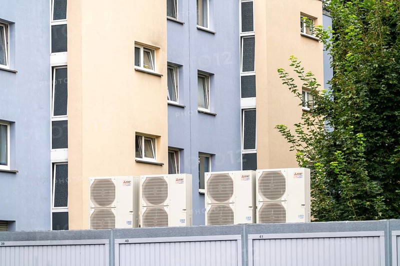 Heat pumps in a residential area, multi-family houses are supplied with heating, cooling and domestic hot water via these devices, installed on garage roofs, modernisation of the flats, Duisburg, North Rhine-Westphalia, Germany, Europe