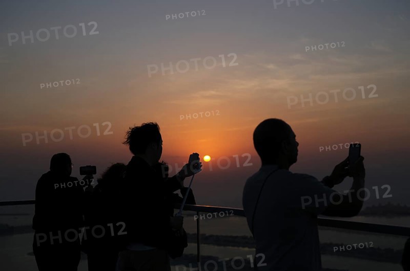 Tourists take selfie with smartphone, selfie stick, The View At the Palm, Palm Jumeirah, sunset, evening mood, Dubai, United Arab Emirates, VAR, Asia