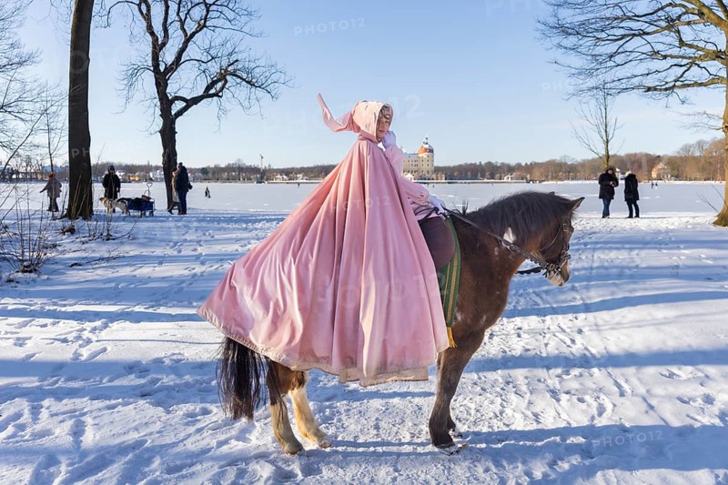 This year, the most popular fairytale film of all time is celebrating a special anniversary. At Moritzburg Castle, one of the film's locations, the exhibition on the cult film Three Hazelnuts for Cinderella is opening for the twelfth time - with an anniversary-worthy supporting programme and special exhibition. Model Tamara Kretschmer once again slipped into the coveted role of the legendary Cinderella with the ball gown. Here she rides the legendary film horse Catano, Moritzburg, Saxony, Germany, Europe