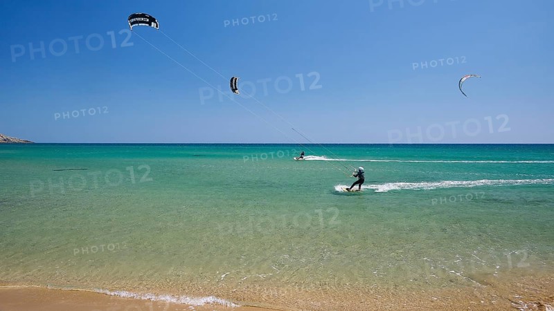 Kitesurfer on turquoise blue sea near the beach under a clear blue sky, surfers paradise, kitesurfer, windsurfer, Prasonisi, island in the south of Rhodes, Rhodes, Dodecanese, Greek Islands, Greece, Europe