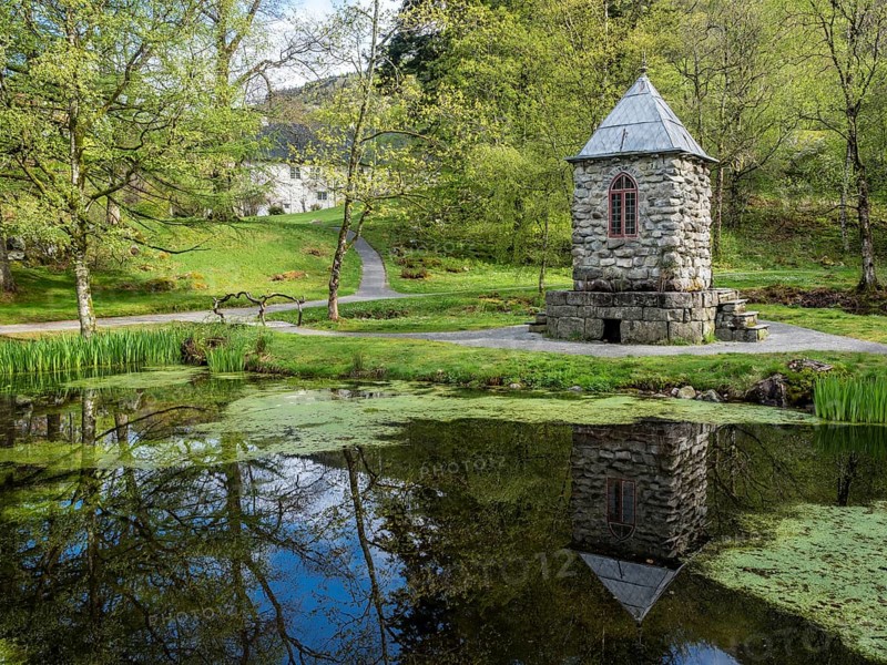 Springtime at the park of baroniet Rosendal, pond with tower, old castle, Rogaland, Norway, Europe