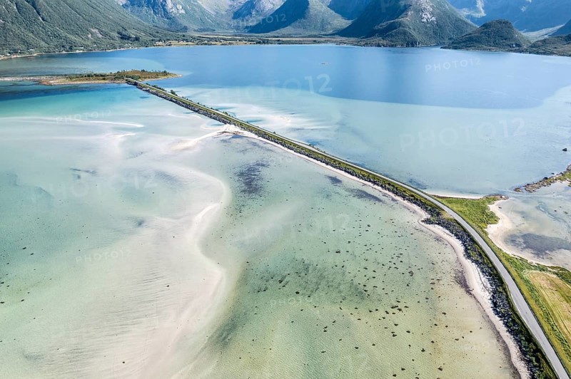 Aerial view of a bridge over turquoise sea at a sandy beach, fjord Grunnforfjorden, Lofoten islands, Norway, Europe