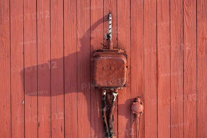 Old electrical junction box from Siemens, red painted wooden wall, Ny-Ålesund, Kongsfjord, Spitsbergen Island, Svalbard and Jan Mayen archipelago, Norway, Europe