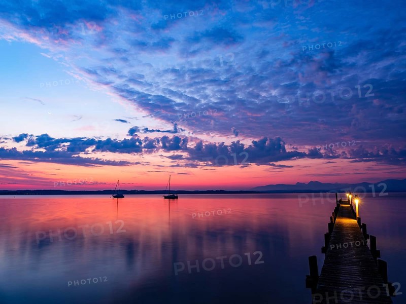 Sailing boats and jetty on Lake Chiemsee at dawn, with the Chiemgau Alps in the background, Chiemgau, Upper Bavaria, Bavaria, Germany, Europe