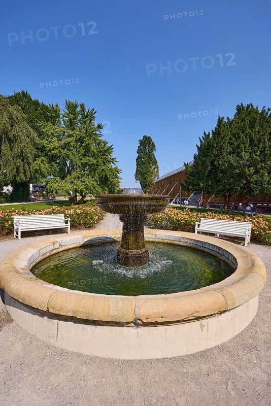Fountain with benches, graduation tower and trees in the rose garden park in Bad Salzuflen, Lippe district, North Rhine-Westphalia, Germany, Europe