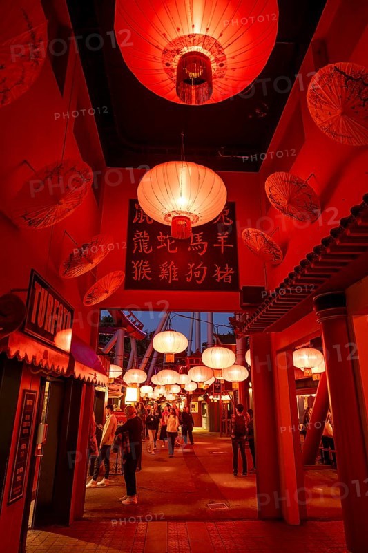 Visitors, Chinese neighbourhood with red lanterns and traditional signs with characters, illuminated at night, Tivoli Amusement and Recreation Park, Copenhagen, Denmark, Europe